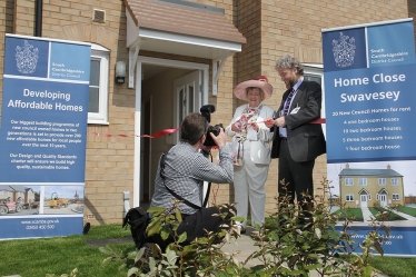 Councillor Sue Ellington, at the time Chairman of SCDC, and Stephen Hills, SCDC's Director of Housing, cutting the ribbon in May 2016 in front of the new, four bedroomed council house in Swavesey.