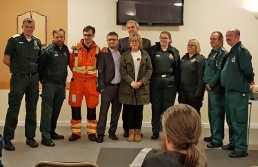 The team from EEAST which saved County Councillor Kevin Cuffley's life after he suffered a massive heart attack on 12th June 2018.  L to R: George Smith, David Killingback, Dr Scott Knapp, Kevin Cuffley (patient), Carol Cuffley, Hannah Fryer, Bryony Oxborrow, Pete Meads and Harvey Steven.  Councillor Brian Milnes, who did the initial CPR on Kevin, is standing behind Kevin and Carol.